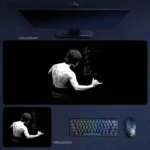Bruce Lee desk mat featuring a monochrome back portrait on a deep black background