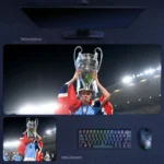 Haaland Trophy Lift Desk Mat featuring Haaland raising the Champions League trophy for Manchester City under stadium lights