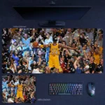 Kobe Bryant Lakers Coronation Desk Mat featuring Bryant with outstretched arms under confetti as the crowd surrounds a championship moment in Lakers colors