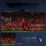 Mohamed Salah Liverpool Desk Mat featuring Salah leading a full Anfield celebration scene with Liverpool players and supporters, shown in two sizes