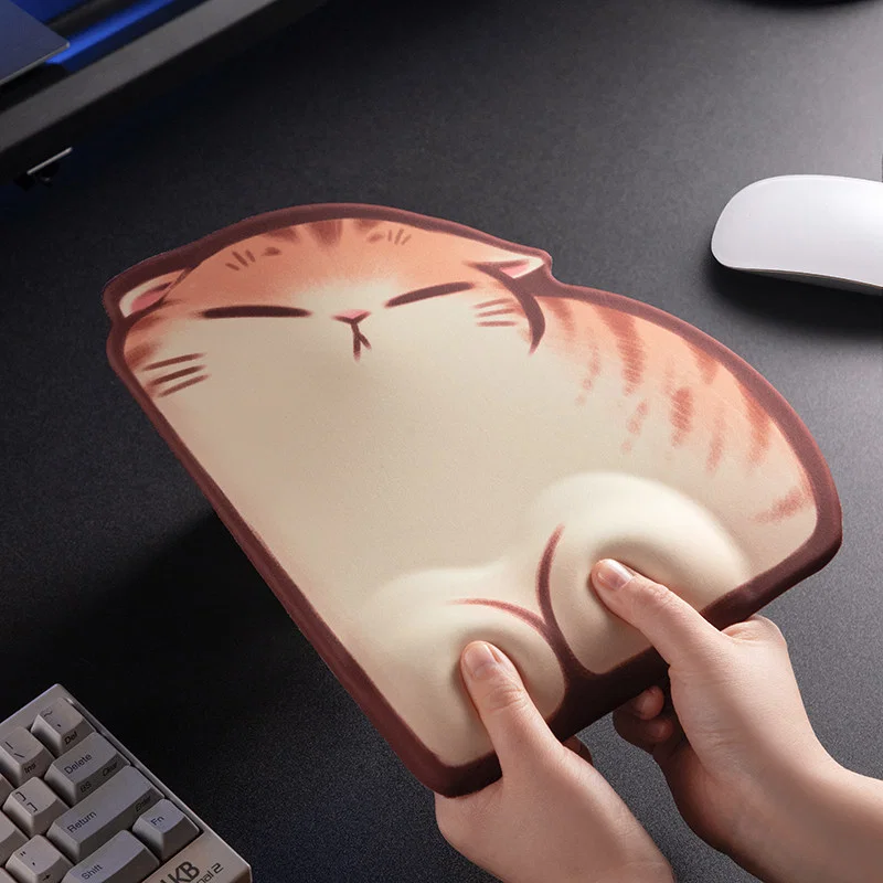 Sleepy Orange Tabby Wrist Rest Mouse Pad being pressed by hands to show the cushioned wrist hump and rebound support on the cat-shaped pad.