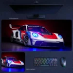 Porsche 911 GT3 desk mat with dramatic race livery and bright blue lighting accents