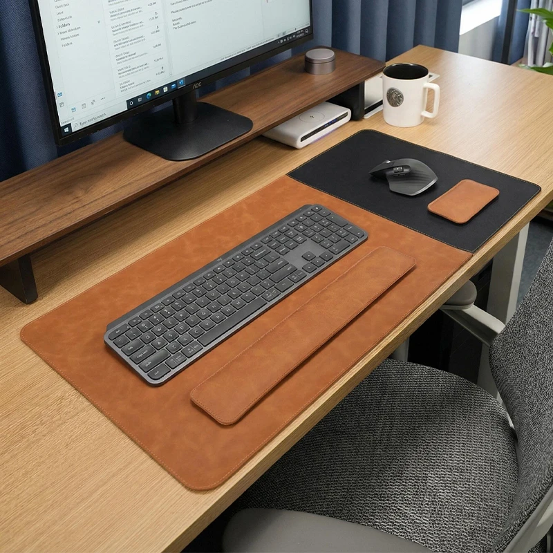 Executive Leather Desk Pad and Wrist Rest Set shown on a wooden office desk with keyboard, mouse area, and matching wrist rests