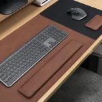 Walnut brown leather desk pad and wrist rest set with coordinated keyboard and mouse support for a composed business workspace