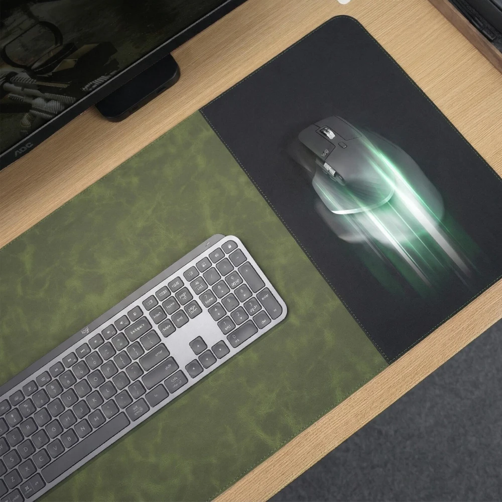 Close-up of the black fabric mouse area on the executive desk mat showing smoother tracking next to the leather keyboard section