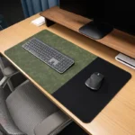 Green executive leather desk mat with a black fabric mouse area, shown on a wood office desk with keyboard and mouse