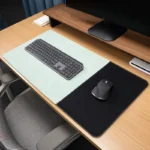 Mint executive leather desk mat with a black fabric mouse area shown on a wood office desk with keyboard and mouse