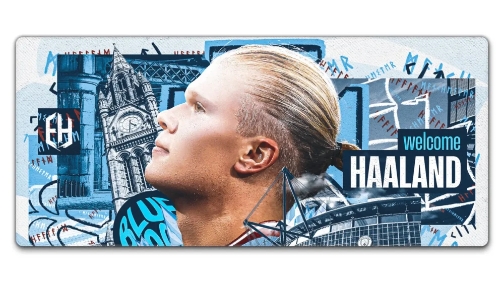 Haaland Man City Welcome Desk Mat in 900 x 400 mm with signing-poster artwork, Manchester landmarks, and Etihad Stadium details.