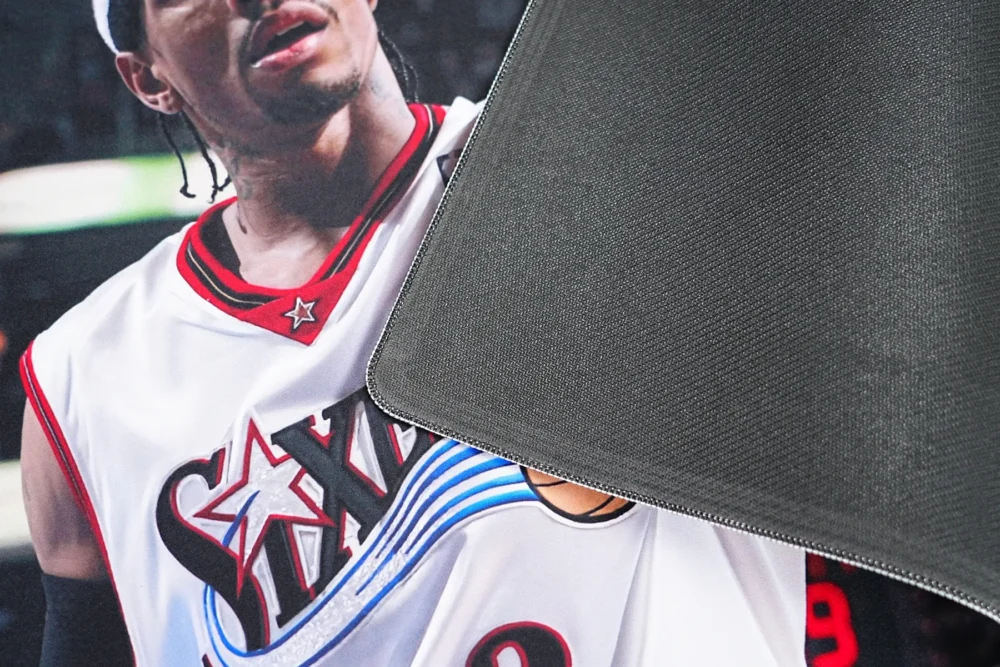 Close-up of basketball mouse mat backing with textured anti-slip rubber base and stitched edge for better grip and edge protection