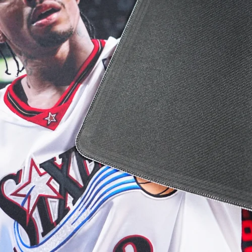 Close-up of basketball mouse mat backing with textured anti-slip rubber base and stitched edge for better grip and edge protection