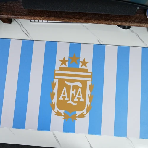 Argentina Blue White Football Desk Mat Blue-white Argentina football desk mat fully laid out with gold crest-style artwork, rounded corners, stitched edges, and wide desk coverage