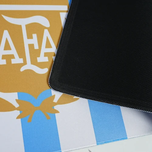 Anti Slip Argentina Football Desk Mat Base Argentina football desk mat lifted to show black anti-slip rubber base, flexible 4mm structure, stitched edge, and blue-white printed top