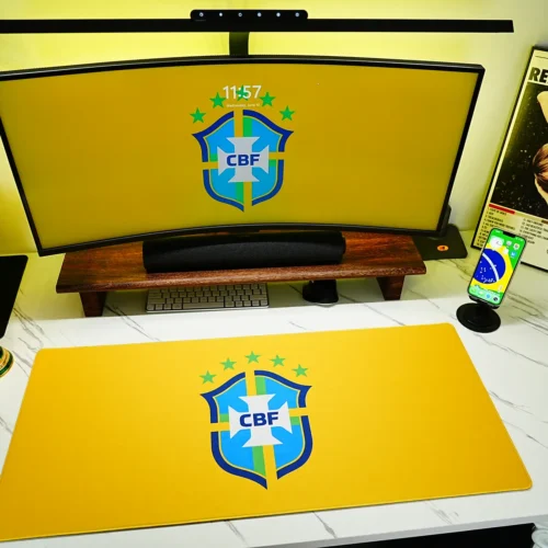 Brazil Football Team Desk Mat shown in a yellow fan desk setup with matching monitor wallpaper, phone wallpaper, and World Cup trophy decor