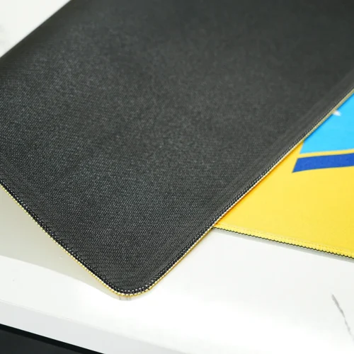 Anti-slip rubber base of a football desk mat with stitched edges and flexible 4mm construction for stable desk use