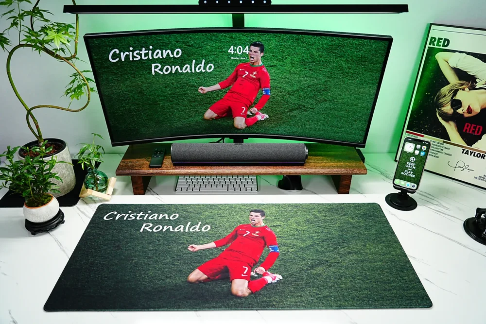 Cristiano Ronaldo Mouse Pad for Football Desk Setup Cristiano Ronaldo Mouse Pad displayed in a full football desk setup with monitor, keyboard, phone stand, soundbar, plants, and green lighting