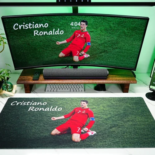 Cristiano Ronaldo Mouse Pad for Football Desk Setup Cristiano Ronaldo Mouse Pad displayed in a full football desk setup with monitor, keyboard, phone stand, soundbar, plants, and green lighting