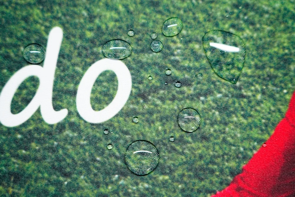 Ronaldo Mouse Pad with Spill-Resistant Fabric Water droplets sitting on Ronaldo mouse pad spill-resistant fabric, showing easier cleanup after small desk spills