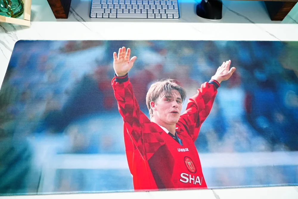 Close-up of the David Beckham tribute desk mat print, showing facial detail, raised-arm celebration, and smooth color transitions for a clear and expressive football image
