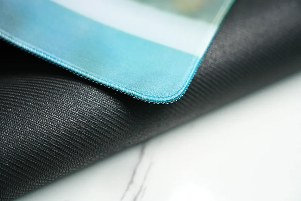 Close-up of the stitched edge on the David Beckham desk mat, showing a reinforced border that keeps the surface and base neatly joined for a cleaner finish