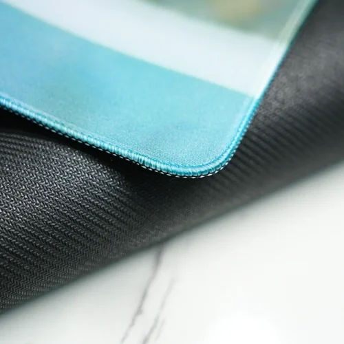 Close-up of the stitched edge on the David Beckham desk mat, showing a reinforced border that keeps the surface and base neatly joined for a cleaner finish