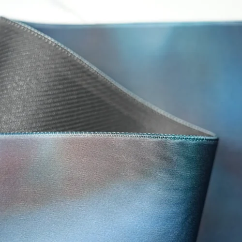 David Beckham desk mat lifted to show the flexible rubber base, revealing a bendable structure that supports easy storage, repositioning, and stable desktop placement
