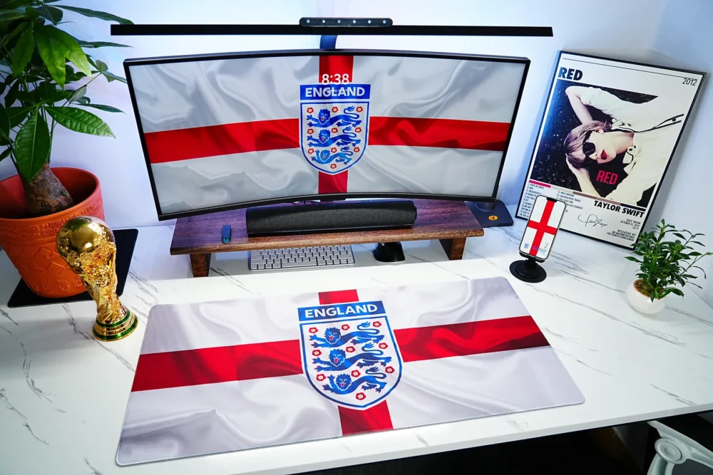 England World Cup Football Desk Mat shown with matching screen wallpaper, trophy decor, and football desk accessories for a unified fan setup