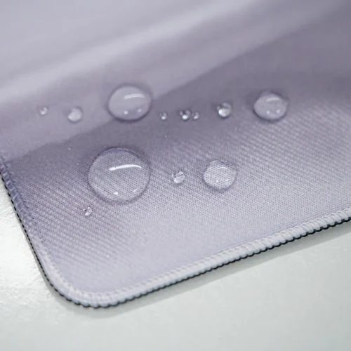 Spill-resistant England desk mat surface with water droplets staying on top to reduce soaking, stains, and interrupted mouse use