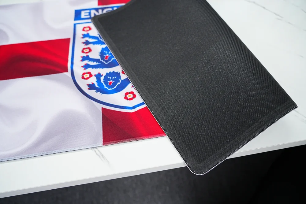 England desk mat back side showing anti-slip rubber base and stitched edge for stable placement and reduced edge fraying