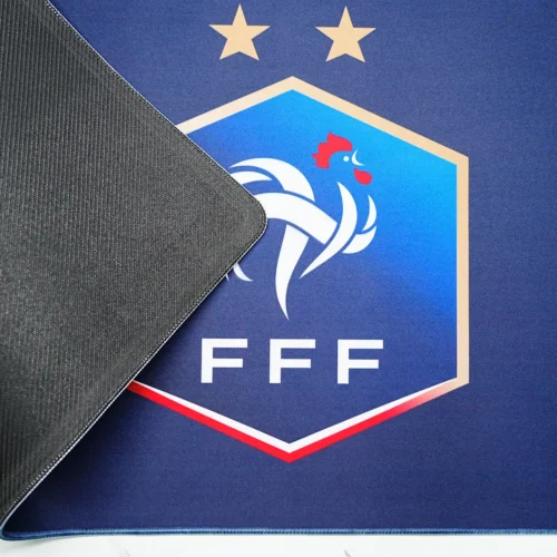 Anti-Slip Rubber France Football Desk Mat France football desk mat lifted to show textured rubber backing, flexible body, and stitched edge for stable desk placement