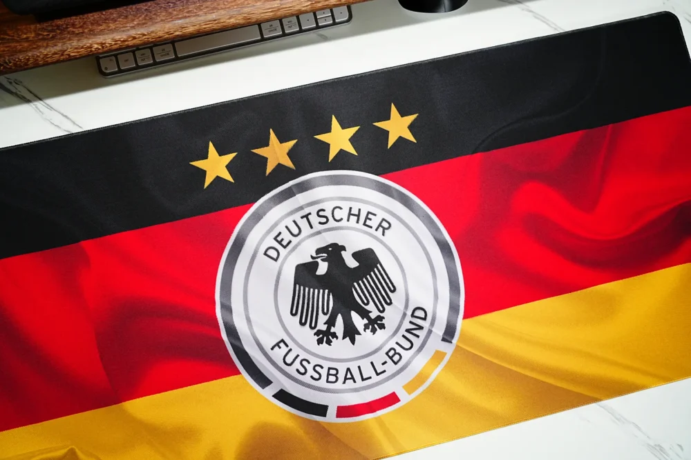 Close-up of Germany flag football desk mat print showing sharp crest detail, four stars, and vivid black red gold color