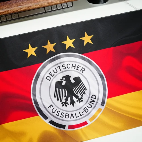 Close-up of Germany flag football desk mat print showing sharp crest detail, four stars, and vivid black red gold color