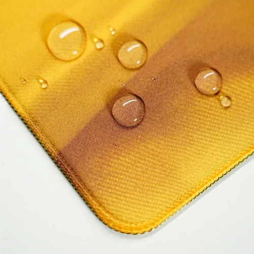 Water drops sitting on the Germany football desk mat surface with stitched edges for spill resistance and edge protection