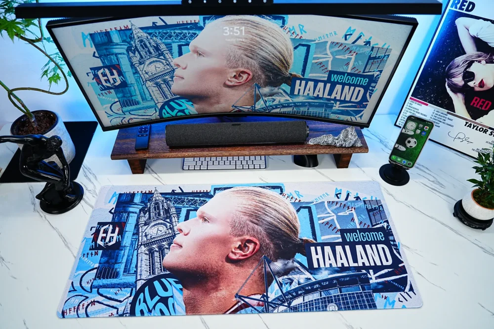 The extended Haaland desk mat spans the main work area, providing enough space for daily accessories while keeping the football artwork visible across the desktop.