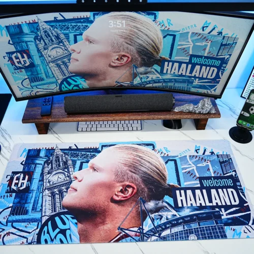The extended Haaland desk mat spans the main work area, providing enough space for daily accessories while keeping the football artwork visible across the desktop.