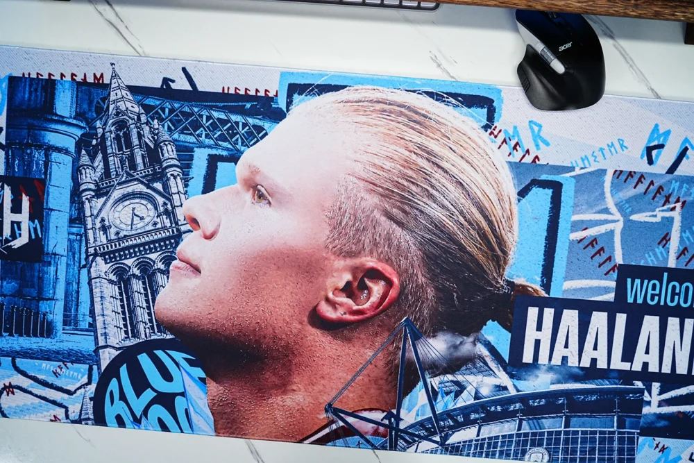 Close-up view of the Haaland welcome poster artwork featuring Manchester landmarks and Etihad Stadium details reproduced with sharp printing and vivid color accuracy.