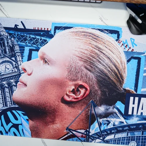 Close-up view of the Haaland welcome poster artwork featuring Manchester landmarks and Etihad Stadium details reproduced with sharp printing and vivid color accuracy.