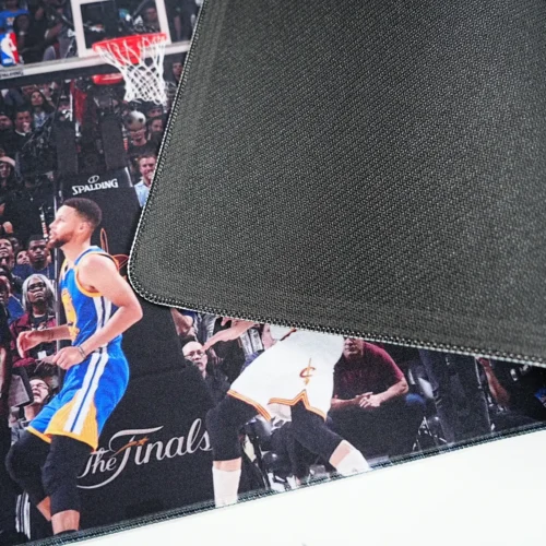Anti slip rubber base and stitched edge shown on a Kevin Durant basketball desk mat for stable long-term desk use