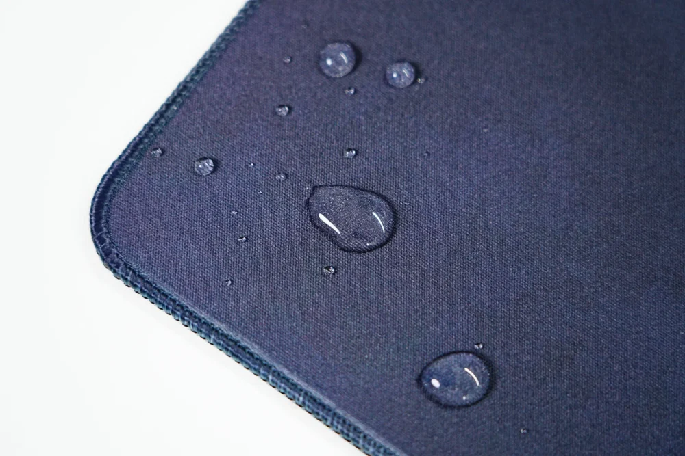 Kobe Bryant mouse pad surface with water drops staying on top to show spill-resistant fabric protection
