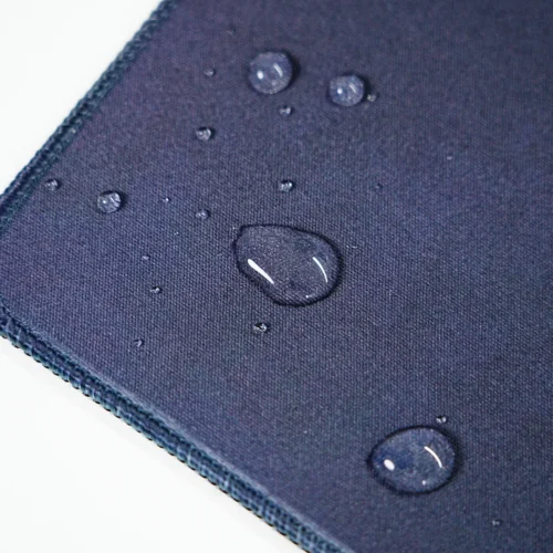 Kobe Bryant mouse pad surface with water drops staying on top to show spill-resistant fabric protection