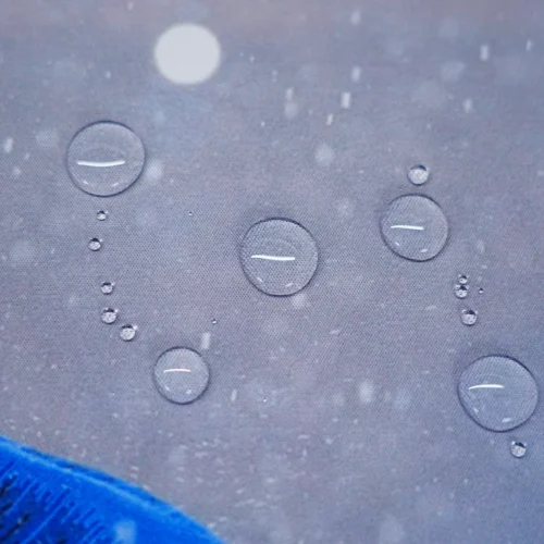 Close-up of Mbappe mouse pad spill-resistant cloth surface showing water droplets staying on top instead of soaking in