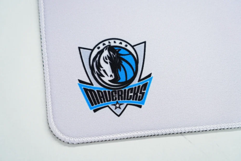Dallas Mavericks Stitched Edge Desk Mat Dallas Mavericks logo and stitched edge detail on the desk mat, showing reinforced borders that help reduce fraying and fabric lift