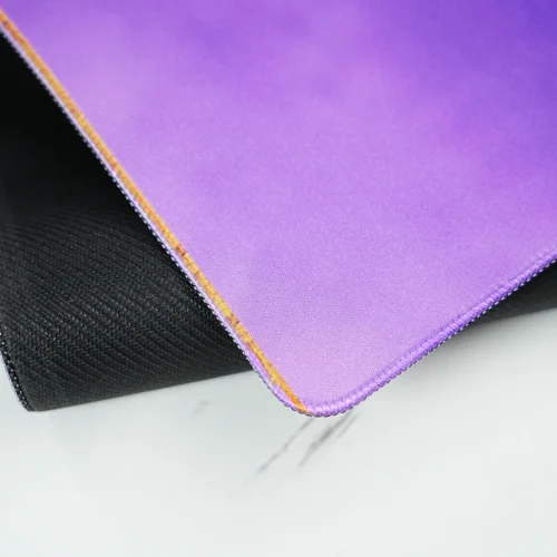 Stitched Edge LeBron Desk Mat Rubber Base LeBron desk mat corner lifted to show stitched edges, fabric surface, and anti-slip rubber base for stable use