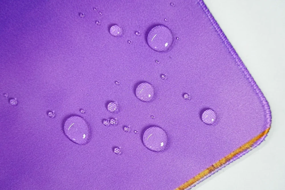 Spill-Resistant LeBron Desk Mat Surface Spill-resistant LeBron desk mat surface with water beads staying on top to protect the artwork during daily use