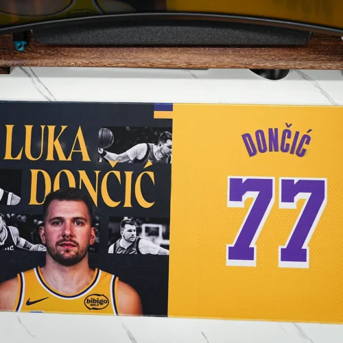 Top view of a Lakers 77 basketball desk pad showing the full Luka-inspired artwork, wide surface, stitched border, and desk fit