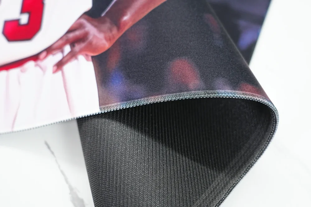 Jordan Bulls Desk Mat Stitched Edge Detail Folded Jordan Bulls desk mat shows stitched edges and textured rubber backing for stable daily use
