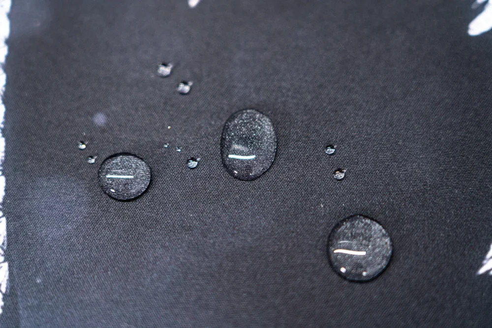 Neymar Jr Soccer Tribute Mouse Pad surface with water droplets beading on the fabric to show the spill-resistant finish