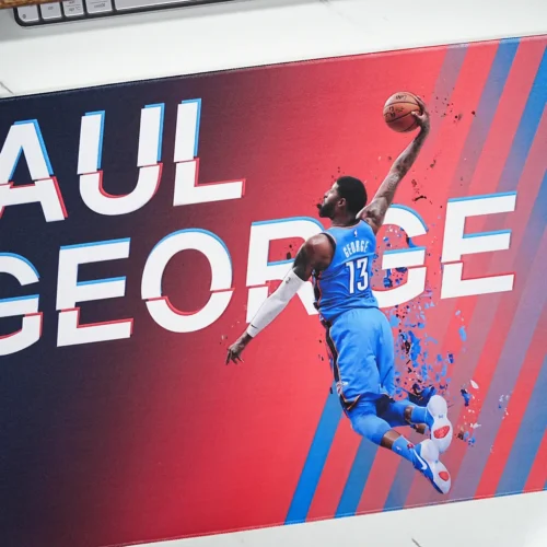 Close-up of Paul George mouse pad artwork showing vivid blue orange color, sharp print detail, and fabric texture