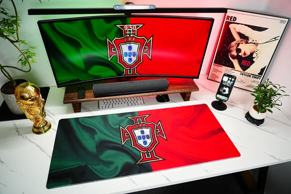 Portugal football desk mat shown in a red green fan setup with matching screen artwork and a World Cup trophy decor for a unified desktop