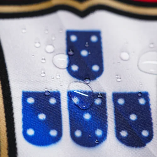 Spill-resistant Portugal football desk mat with water droplets staying on the surface to protect artwork and daily mouse use