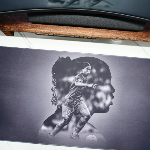 Wide Ronaldinho Barcelona desk mat placed under a monitor setup, giving fans broad desk coverage for keyboard and mouse use